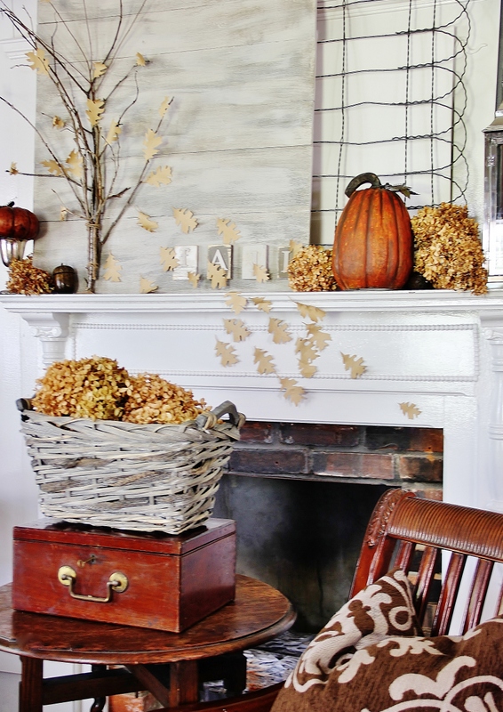 Mantel decorated for fall with pumpkins