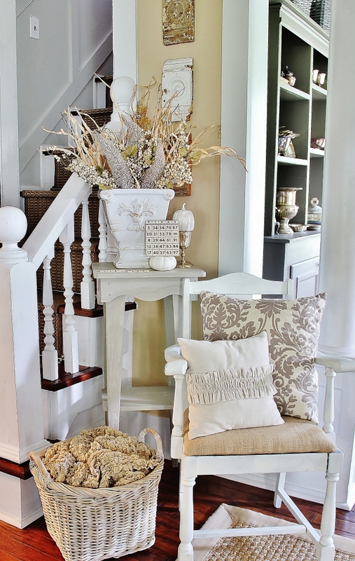 A room filled with furniture and vase of flowers on a table