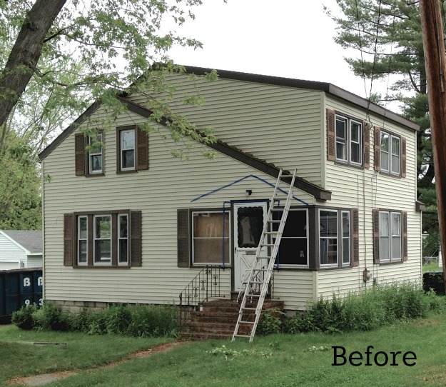 A house with tan siding and brown shutters before makeover