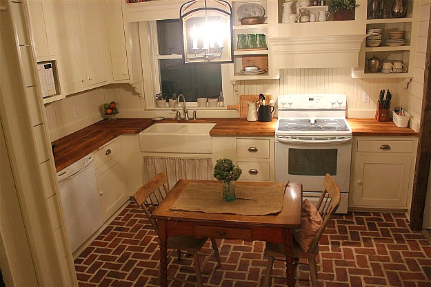 A kitchen with small table and chairs