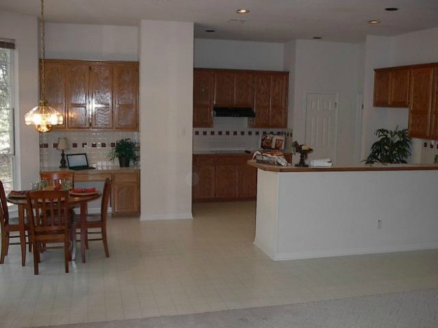 A kitchen with a dining room table before remodel