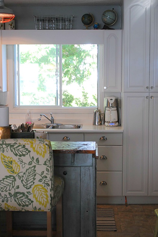 A kitchen with a sink and a window