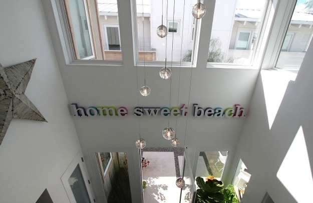 sign on wall that says home sweet beach