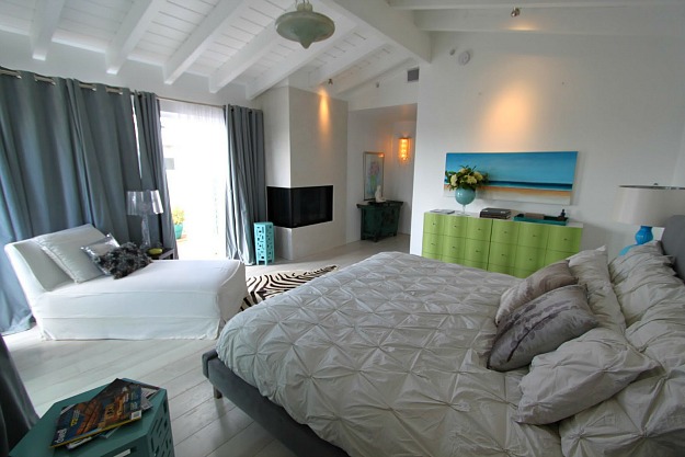A bedroom with a large bed in a room
