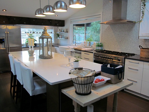 A kitchen with black cabinets and large island