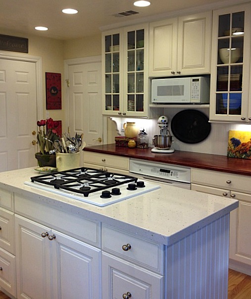 A kitchen with a sink and a microwave