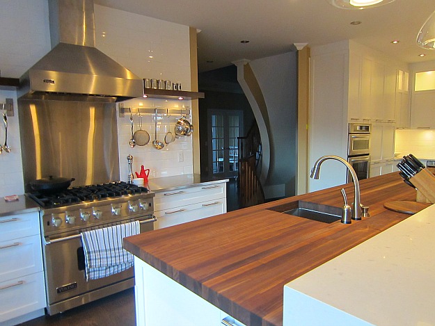 A modern kitchen with stainless steel appliances and wooden cabinets