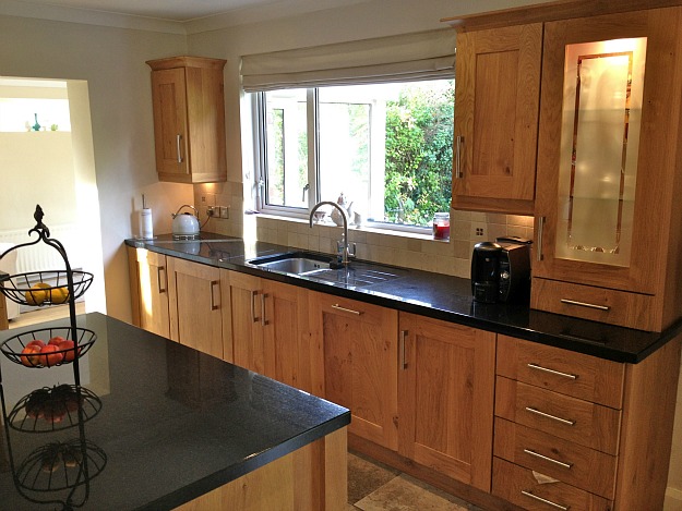 A modern kitchen with stainless steel appliances and wooden cabinets