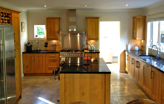 A modern kitchen with stainless steel appliances and wooden cabinets