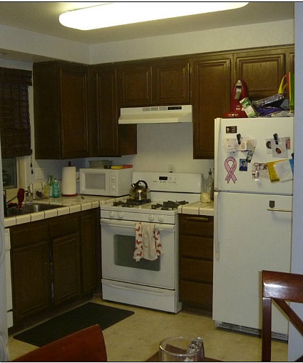 A kitchen with a sink and a refrigerator