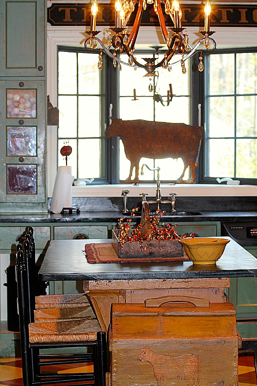 metal cow figurine in kitchen window