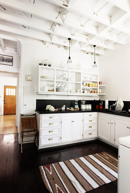 white kitchen with black countertops