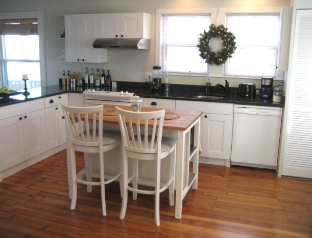 kitchen with small island and barstools