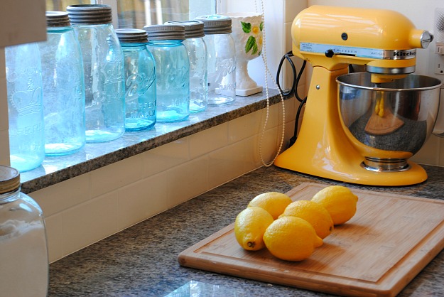 closeup of yellow standing mixer and lemons