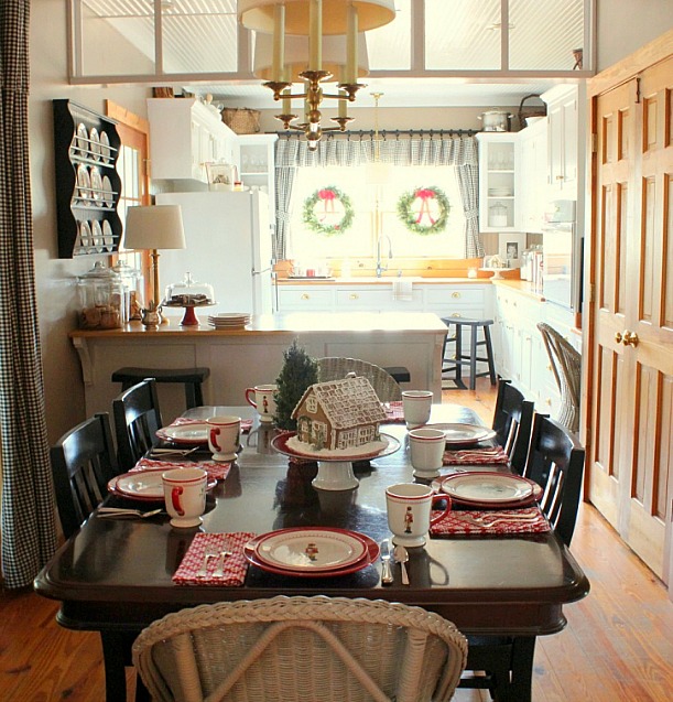 A kitchen with a dining table set for the holidays