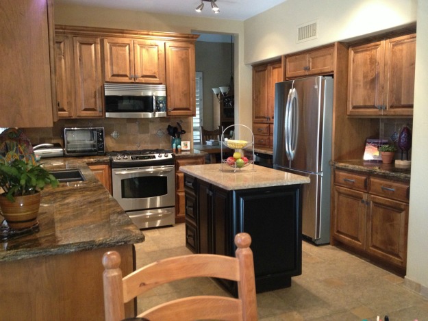 A modern kitchen with stainless steel appliances and wooden cabinets