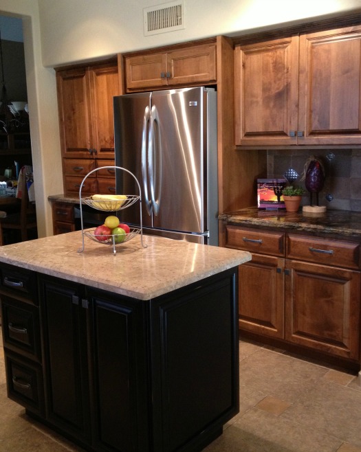 A kitchen with stainless steel appliances and wooden cabinets