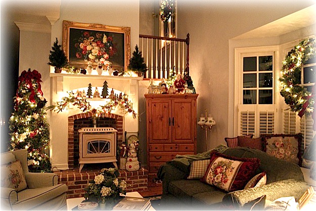 A christmas tree in a living room filled with furniture and a fire place