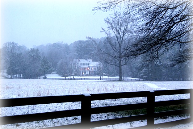 snowy field with house in distance