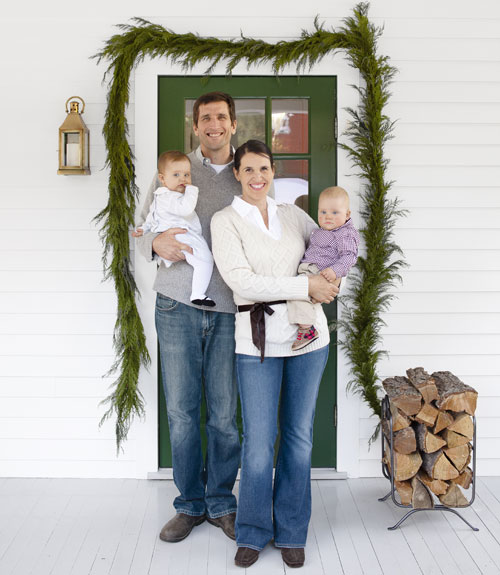 Trina and Mike with their young daughters on the front porch for Country Living