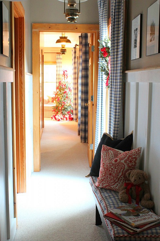 hallway leading to bedroom with Christmas tree