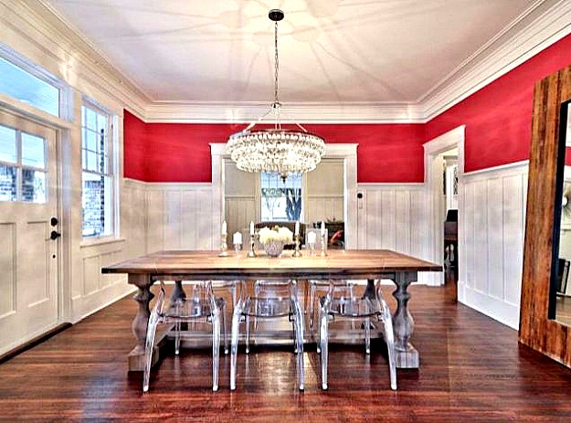 Red dining room with board and batten paneling three quarters up wall