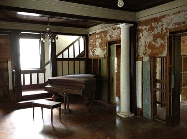 piano and staircase before home remodel