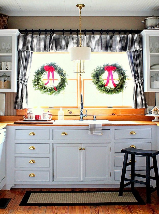 Christmas wreaths on kitchen windows in Kelly\'s house