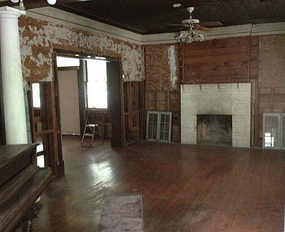 A living room with fireplace before remodel