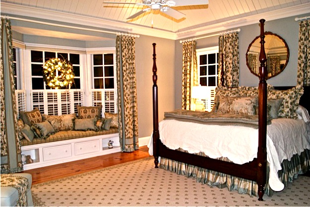 A bedroom with a bed and window seat