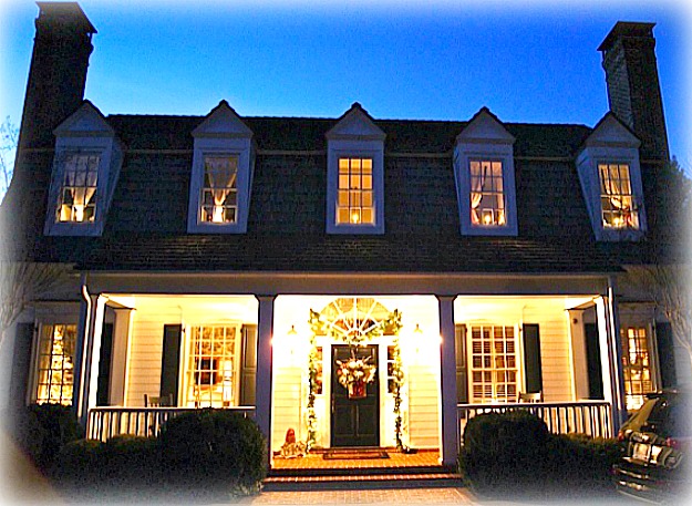 front porch lit up at night with dormers