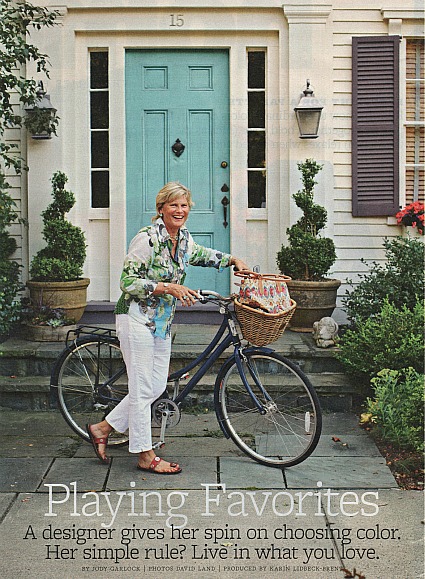 A person with a bicycle in front of a building