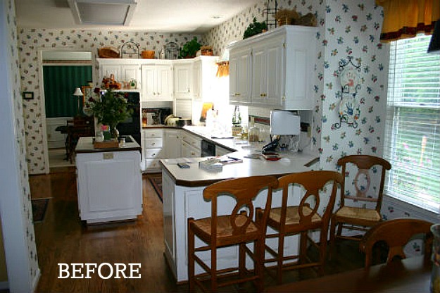 A kitchen before remodel with wallpaper