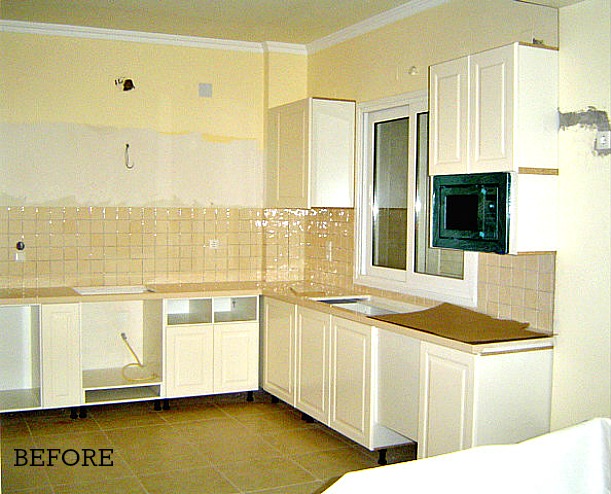 A kitchen with a sink and a microwave before remodel