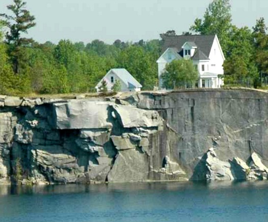 white Victorian overlooking quarry with lake