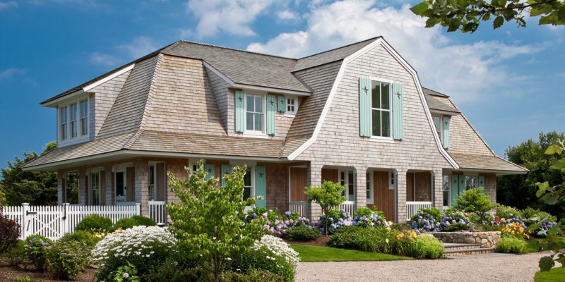 front exterior of Little Beach Shingle style house with aqua blue shutters