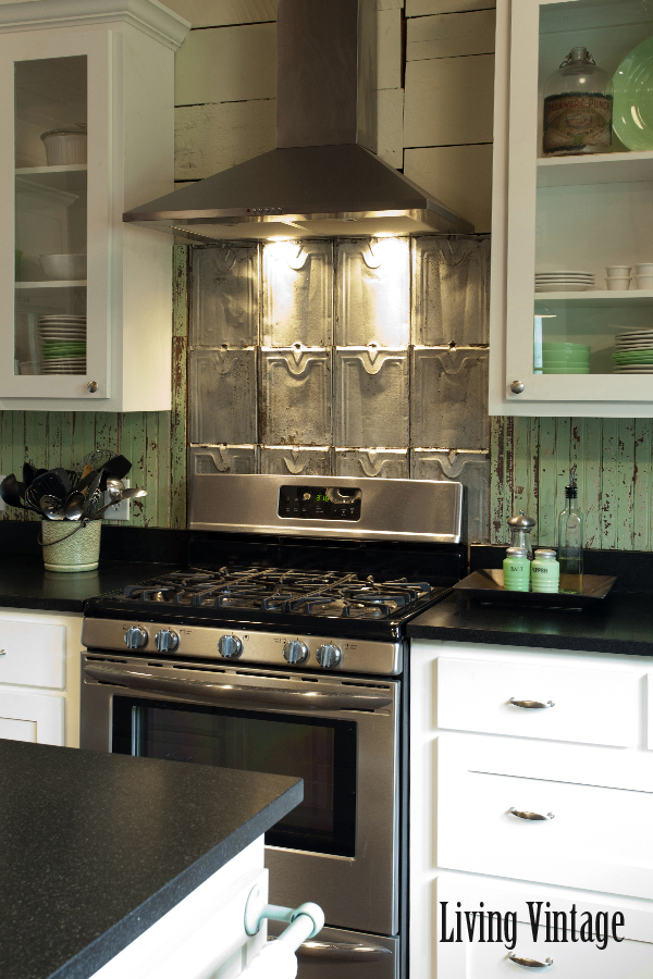 kitchen with white cabinets and black countertops after remodel