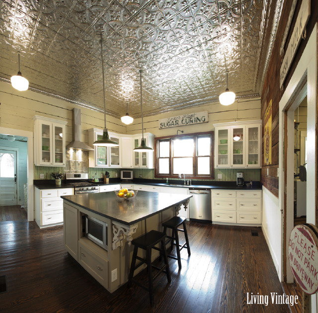 kitchen with white cabinets and black countertops after remodel