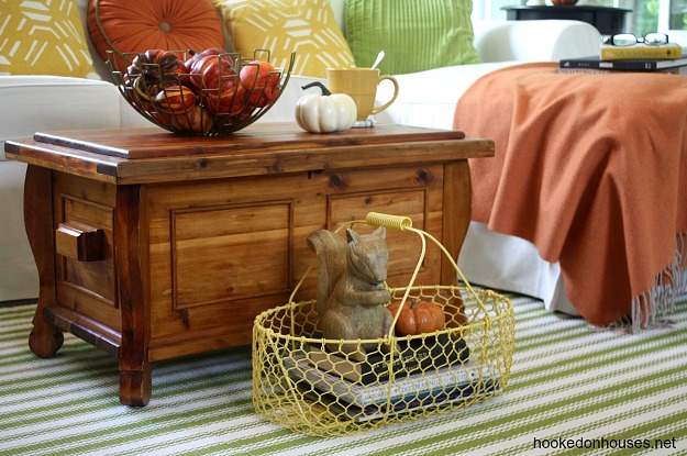 closeup of yellow metal basket with wood squirrel figure