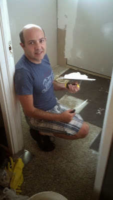 Renato installing new bathroom flooring