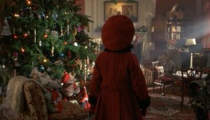 little girl in red coat and hat beside Christmas tree
