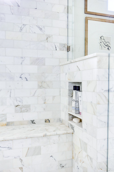 A close up of a tiled wall in shower with niche