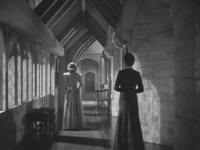 women walking down upstairs hallway in Manderley