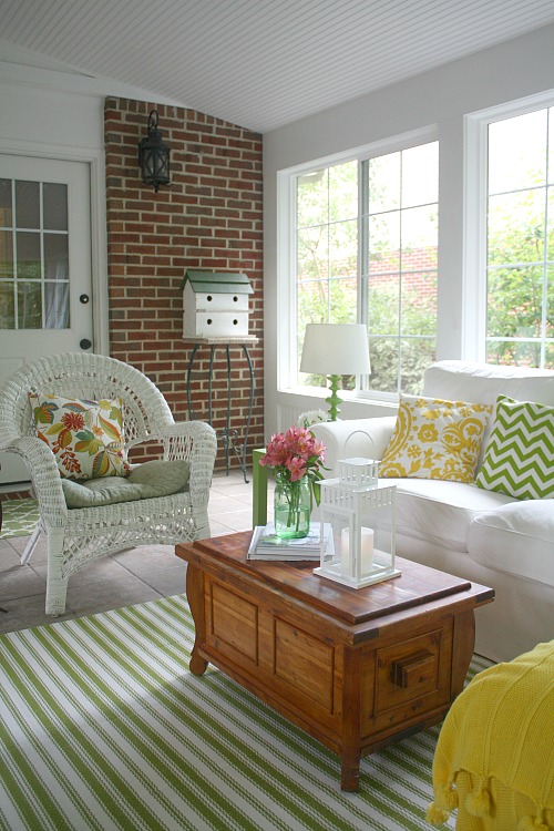 wicker chair and birdhouse in sunroom