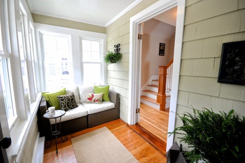 enclosed porch after remodel with small sofa