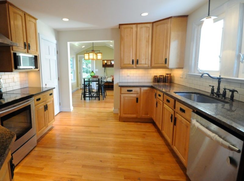 remodeled kitchen with wood floors and cabinets