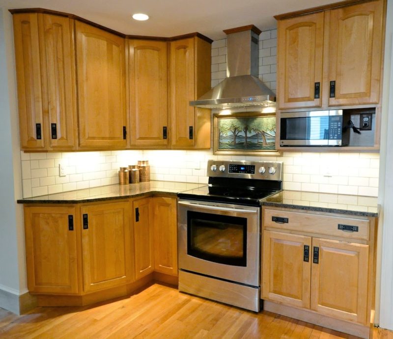 A kitchen with stainless steel appliances and wooden cabinets