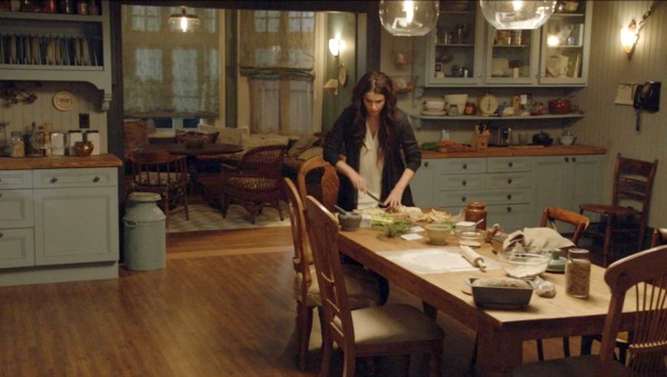 Julia Ormond cooking in a kitchen