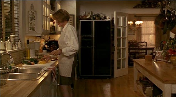 Diane Keaton standing at the sink