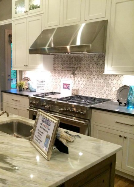 kitchen with stainless steel range and vent hood